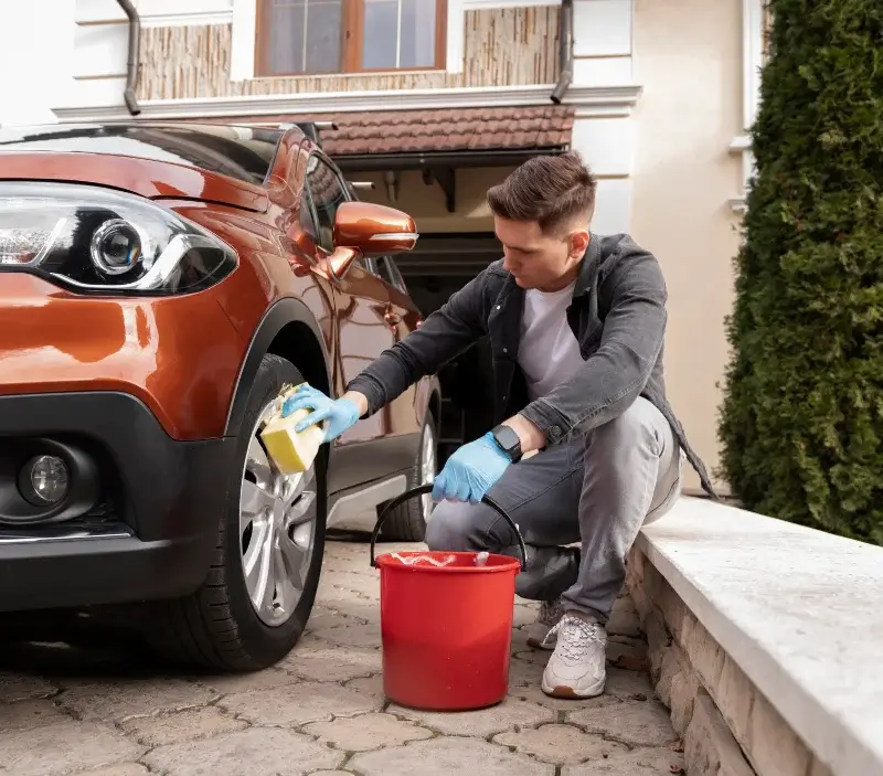 Lavage auto à domicile Poigny-la-Forêt : professionnel intervenant sur un véhicule